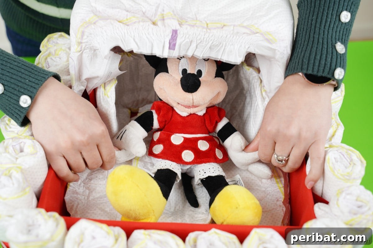 Charming Diaper Bassinet: A Perfect Baby Shower Present 19 Placing a Minnie Mouse stuffed animal and other gifts into the finished bassinet diaper cake.