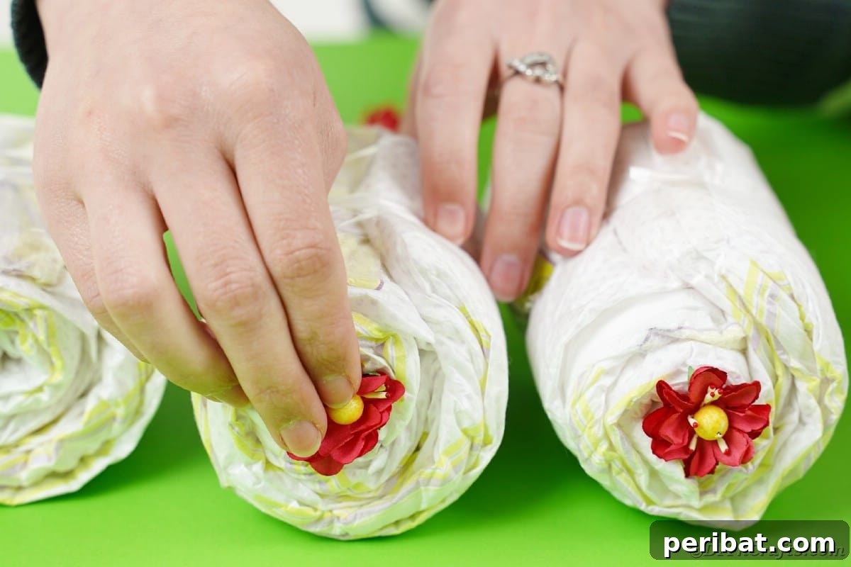 Charming Diaper Bassinet: A Perfect Baby Shower Present 24 Adding flowers to diaper rolls