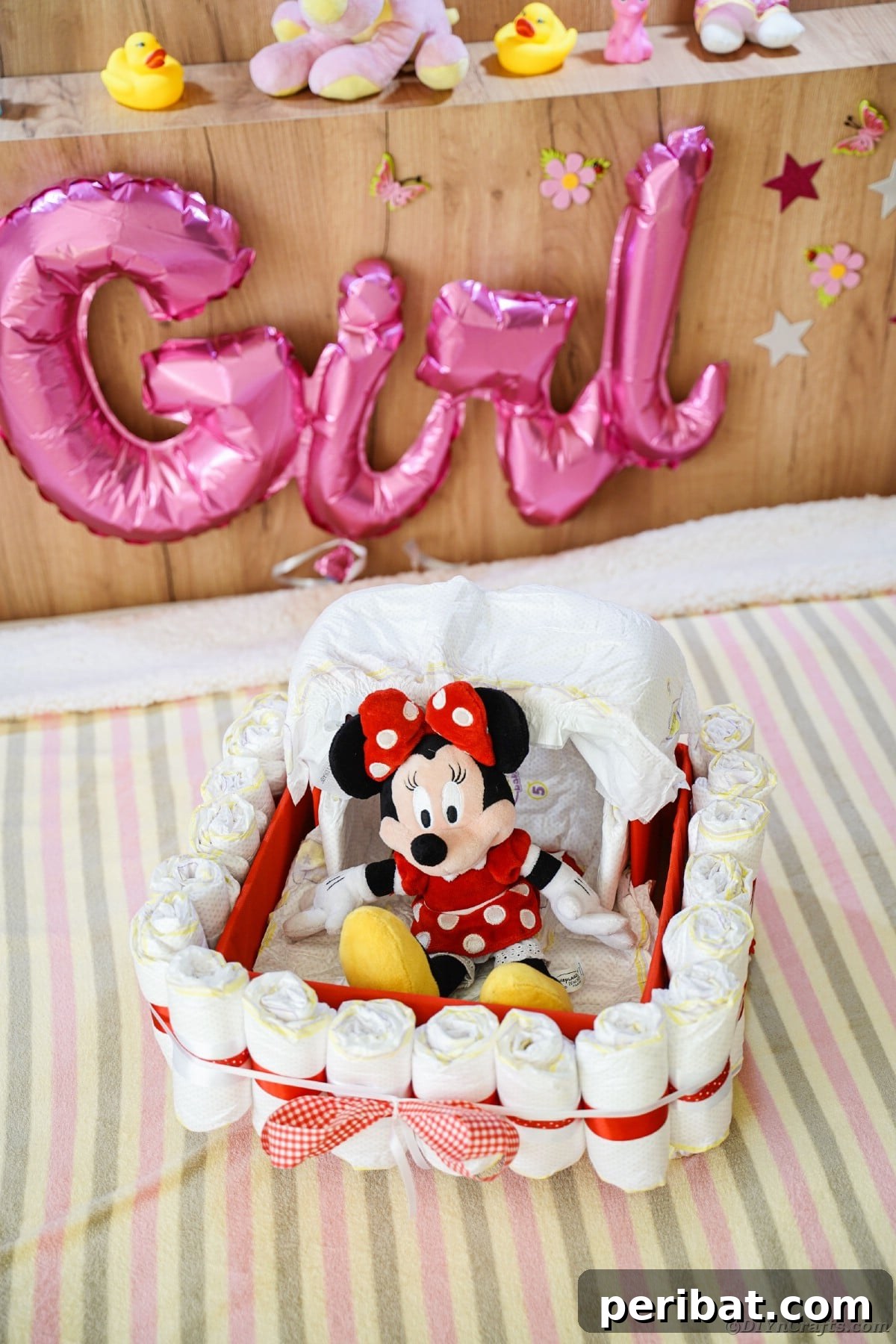 Charming Diaper Bassinet: A Perfect Baby Shower Present 26 Bassinet diaper cake on a bed, filled with baby essentials and a cute stuffed animal, showcasing its utility and charm.