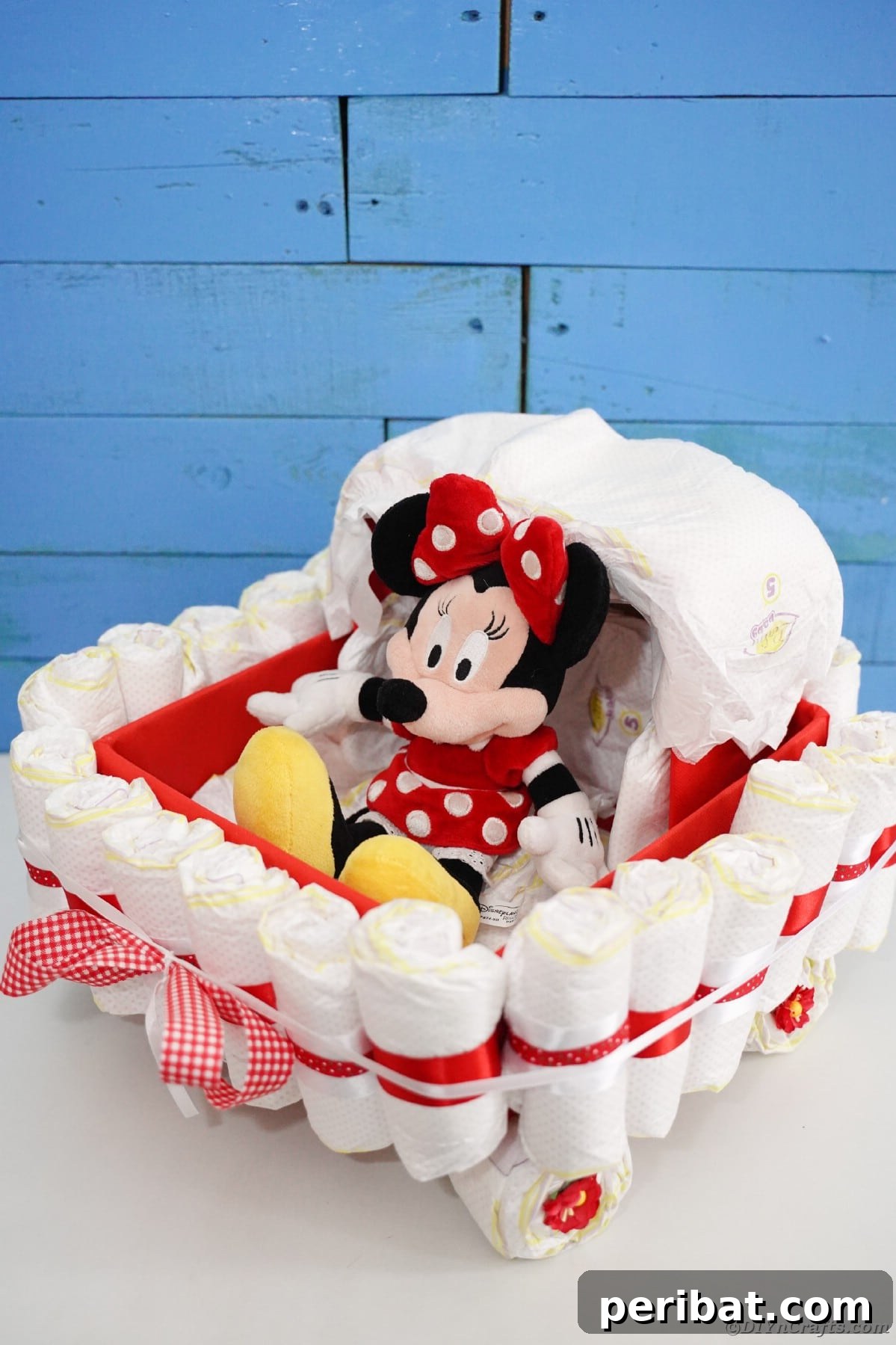 Charming Diaper Bassinet: A Perfect Baby Shower Present 28 Diaper cake bassinet with balloons by a blue wall, creating a festive and adorable baby shower display.