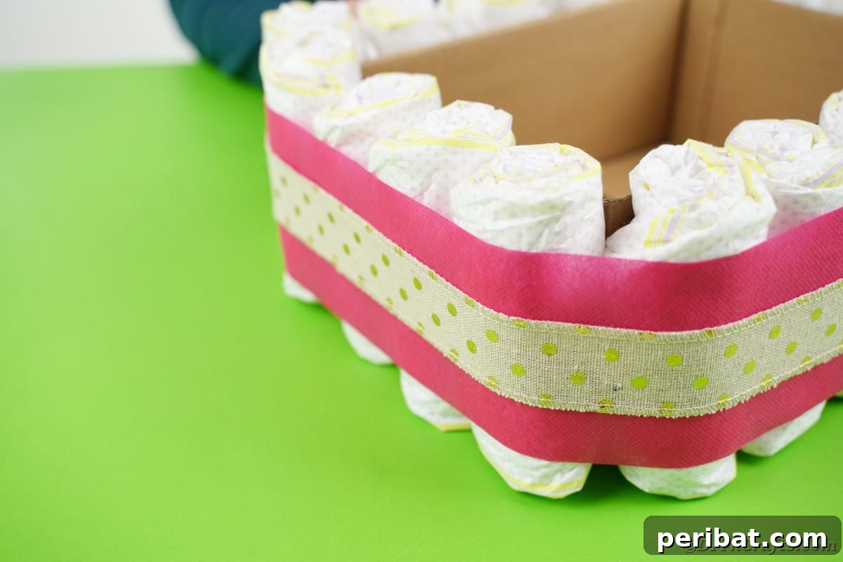 Whimsical Hot Air Balloon Diaper Cake 12 Adding burlap around pink ribbon