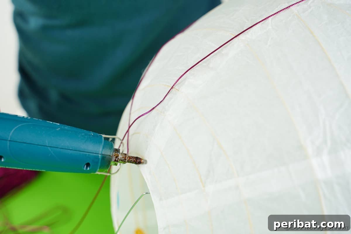 Whimsical Hot Air Balloon Diaper Cake 15 Gluing string on lantern