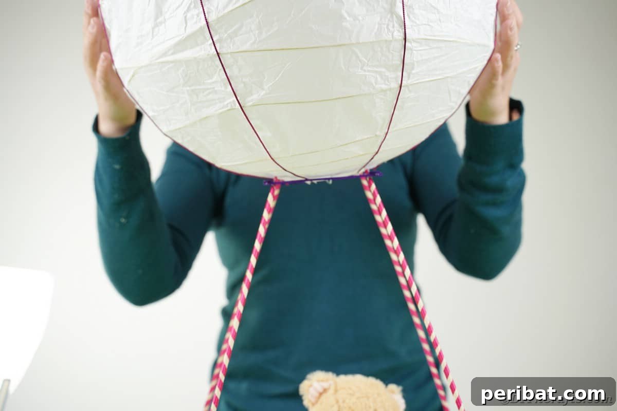 Whimsical Hot Air Balloon Diaper Cake 23 Gluing lantern onto dowels