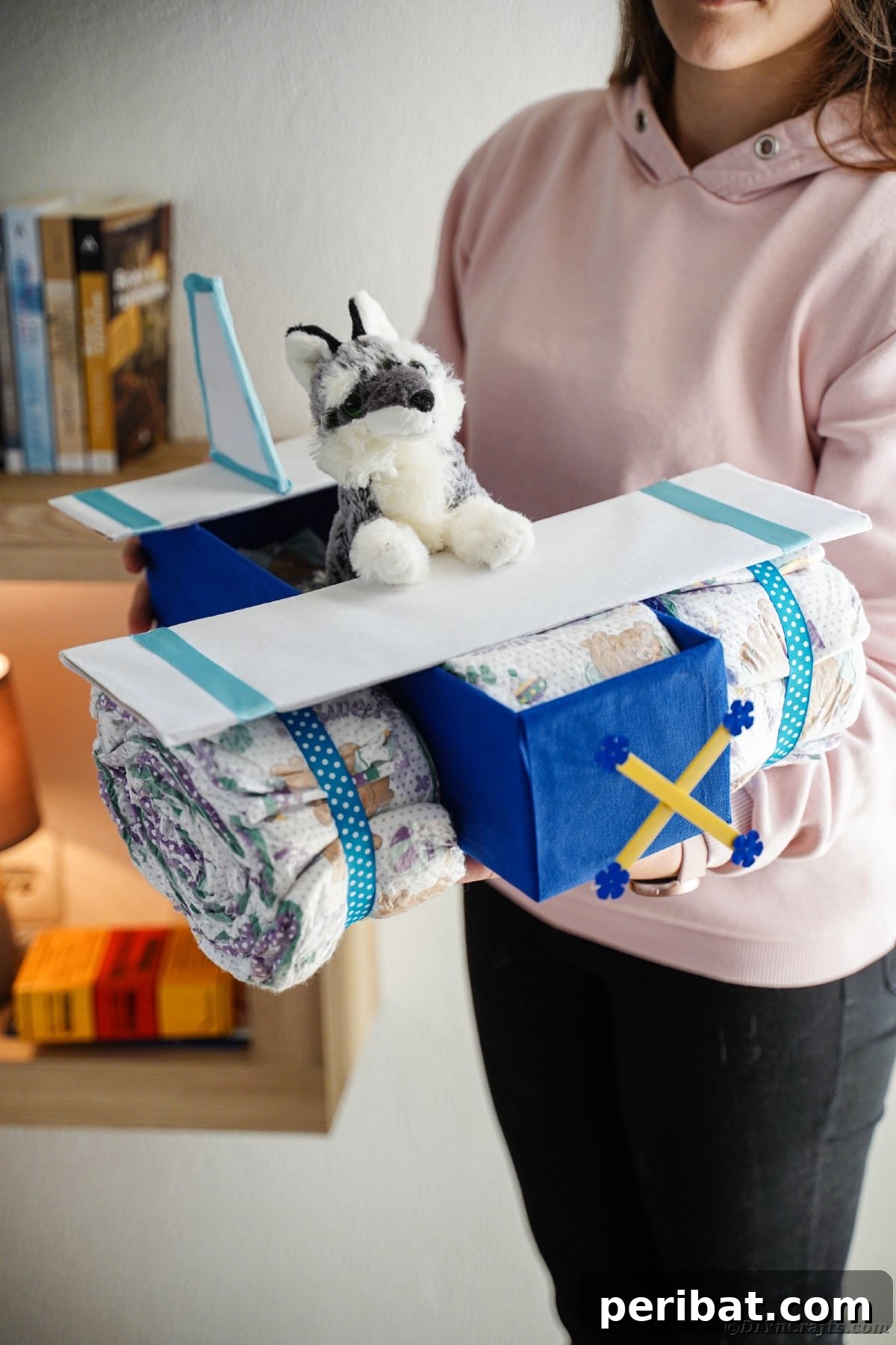 Cloud Nine Diaper Plane Baby Shower Gift 24 Woman holding diaper cake airplane