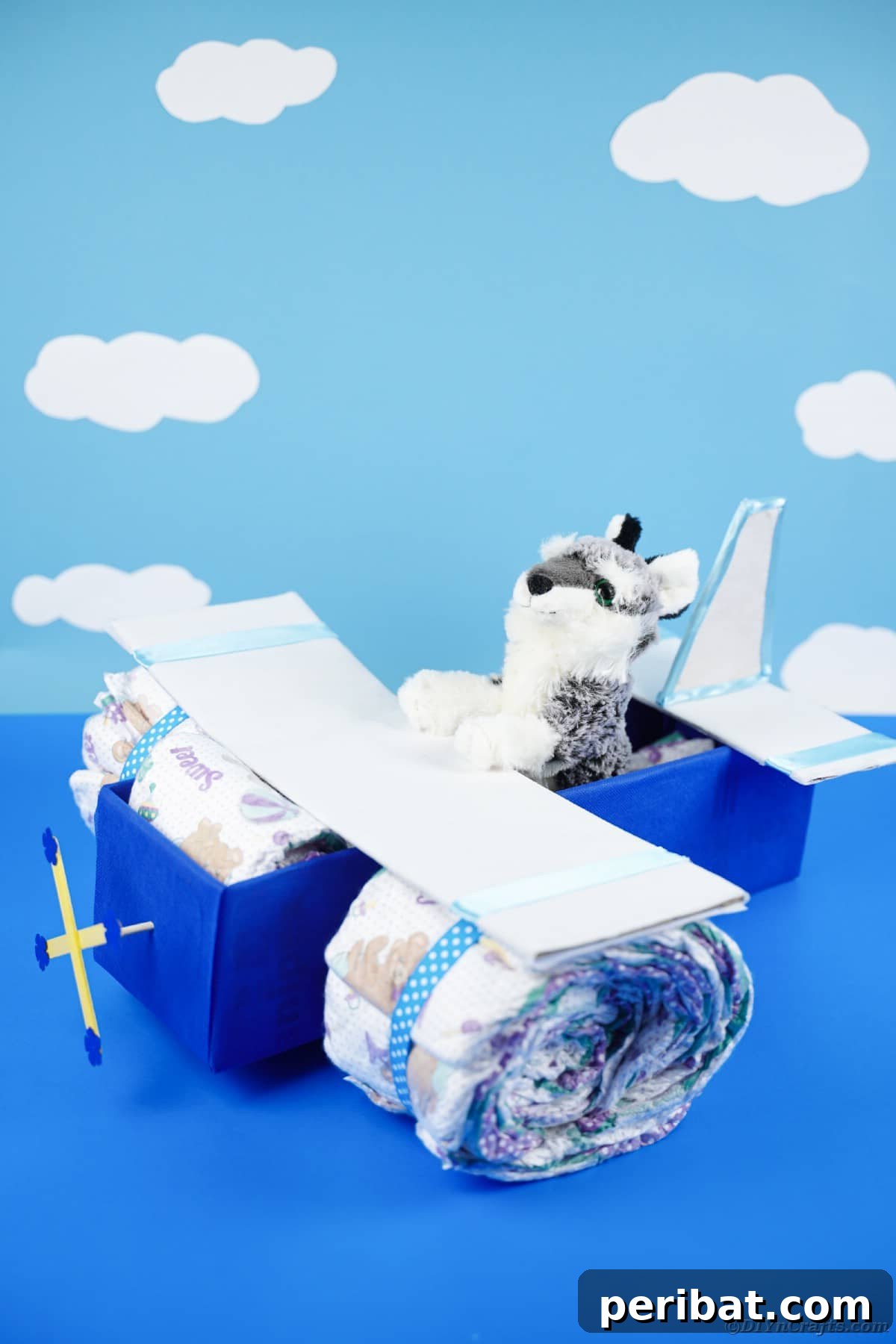 Cloud Nine Diaper Plane Baby Shower Gift 25 Diaper cake in front of cloud paper