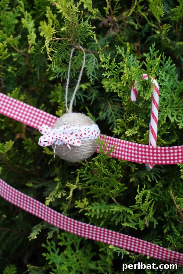 40 Christmas Craft Ideas to Spark Kids' Creativity This Winter Break 12 A rustic twine and lace wrapped Christmas ornament hanging elegantly on a Christmas tree branch, perfect for older kids to craft.
