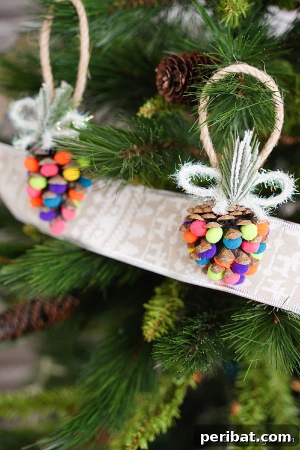 40 Christmas Craft Ideas to Spark Kids' Creativity This Winter Break 15 Vibrant colorful pom-pom pine cone ornaments, transforming ordinary pinecones into festive and playful additions to a holiday tree.