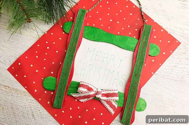 40 Christmas Craft Ideas to Spark Kids' Creativity This Winter Break 21 A personalized DIY craft stick Christmas ornament with a festive message, displayed on red paper, ideal for kids to customize.