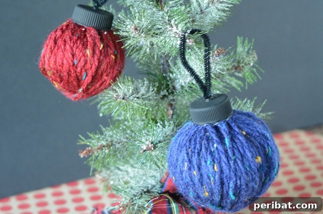 40 Christmas Craft Ideas to Spark Kids' Creativity This Winter Break 22 A cozy yarn ball ornament hanging on a Christmas tree, created from scrap yarn for a charming, rustic touch.