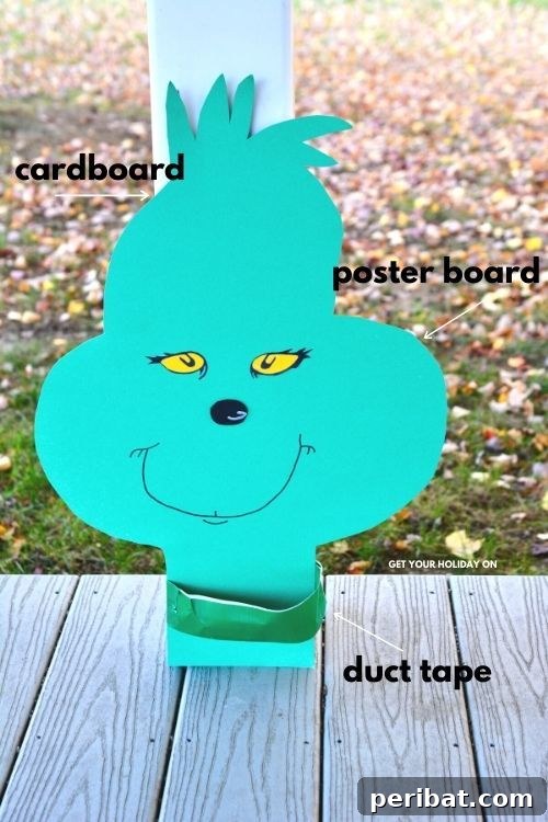 40 Christmas Craft Ideas to Spark Kids' Creativity This Winter Break 36 A festive Grinch face decoration on a porch, part of a collection of adorable Grinch Christmas games and craft ideas for kids.