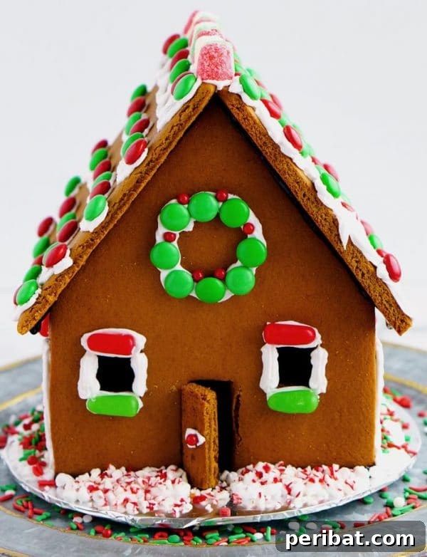 40 Christmas Craft Ideas to Spark Kids' Creativity This Winter Break 37 A beautifully decorated homemade gingerbread house on a table, part of a traditional holiday recipe and craft activity.