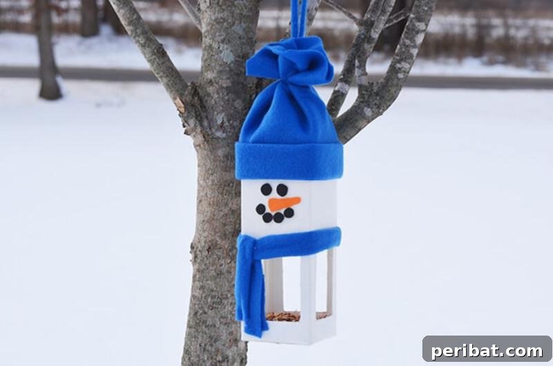 A festive snowman birdhouse or birdfeeder crafted from painted and decorated materials, hanging outdoors in a winter setting, inviting birds.