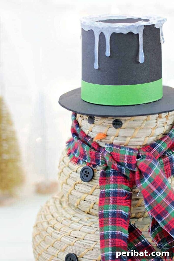 A creative snowman craft made from stacked IKEA baskets, decorated with a painted snowman face and a large top hat, perfect for festive storage.