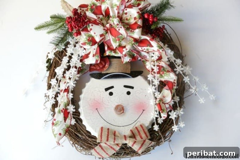 A vibrant and three-dimensional Jolly Snowman Christmas wreath, featuring a cheerful snowman face, festive bows, and various winter embellishments on a green wreath base.