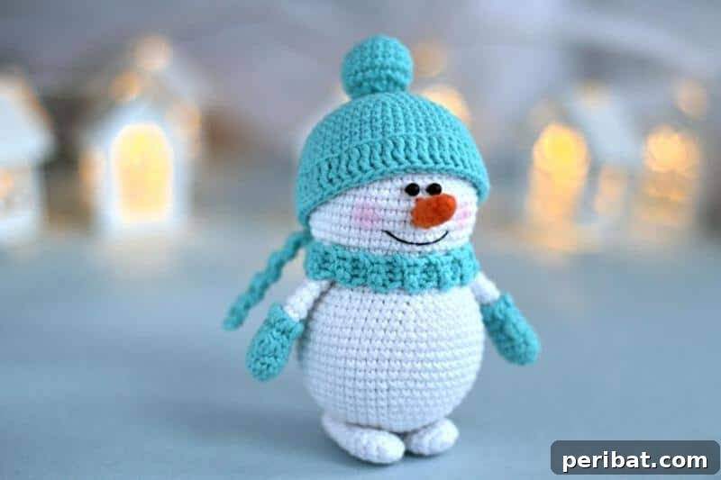 A cuddly amigurumi crochet snowman toy, handcrafted with white yarn, featuring stitched facial details, a tiny scarf, and a charming, huggable design.