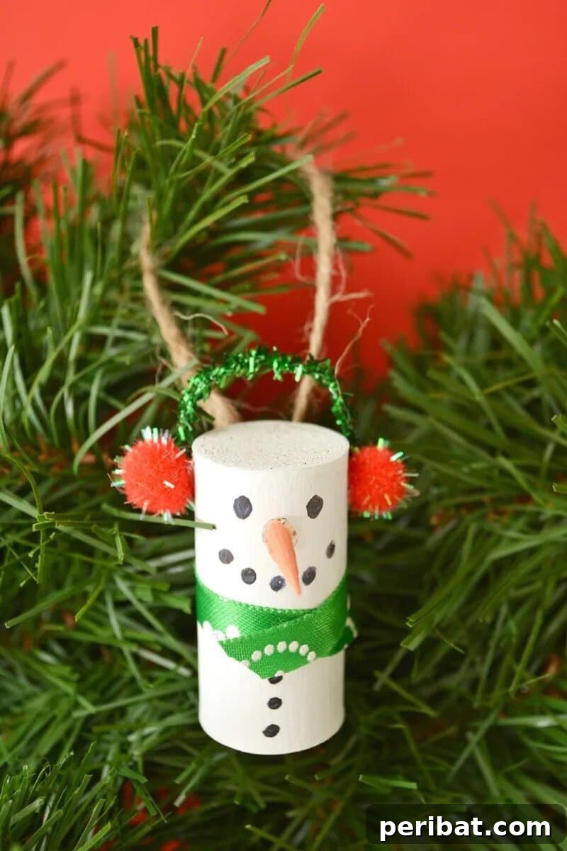 Three cute snowman ornaments made from upcycled wine corks, each painted white with drawn faces, tiny scarves, and a loop for hanging.