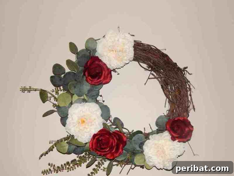 Rustic Farmhouse Wreaths for Year-Round Beauty 11 Beautiful grapevine wreath adorned with large red and white floral elements
