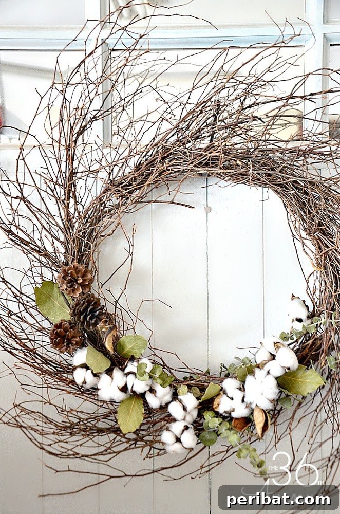 Rustic Farmhouse Wreaths for Year-Round Beauty 17 Grapevine wreath adorned with fluffy cotton bolls and pinecones