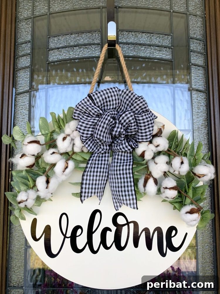 Rustic Farmhouse Wreaths for Year-Round Beauty 19 Welcome sign wreath created with Cricut Joy, featuring a plaid bow