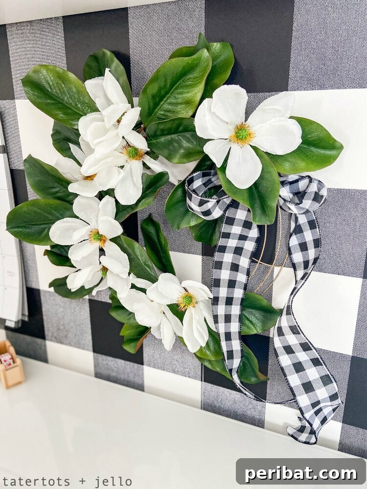 Rustic Farmhouse Wreaths for Year-Round Beauty 23 Magnolia flower wreath accented with checked ribbon