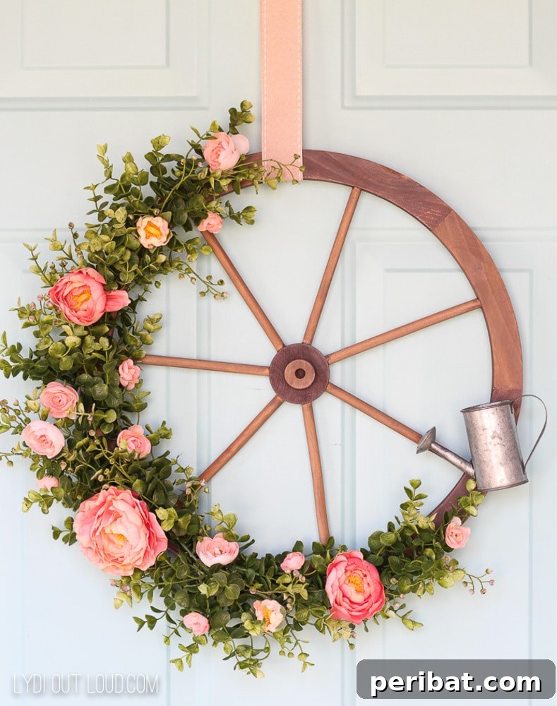 Rustic Farmhouse Wreaths for Year-Round Beauty 27 Wagon wheel wreath adorned with flowers and a small watering can