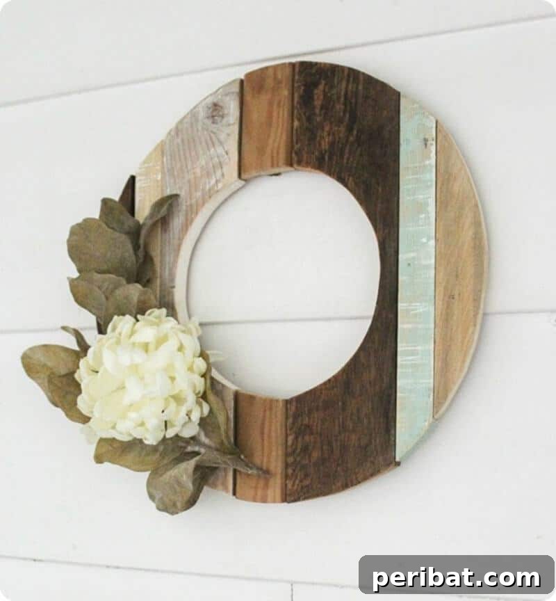 Rustic Farmhouse Wreaths for Year-Round Beauty 29 Rustic reclaimed wood wreath with a beautiful flower accent