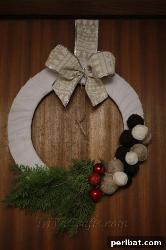 Rustic Farmhouse Wreaths for Year-Round Beauty 5 Yarn-wrapped farmhouse Christmas wreath with decorative yarn balls