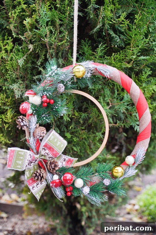 Rustic Farmhouse Wreaths for Year-Round Beauty 6 Christmas wreath with embroidery hoop base, red accents, and natural greenery