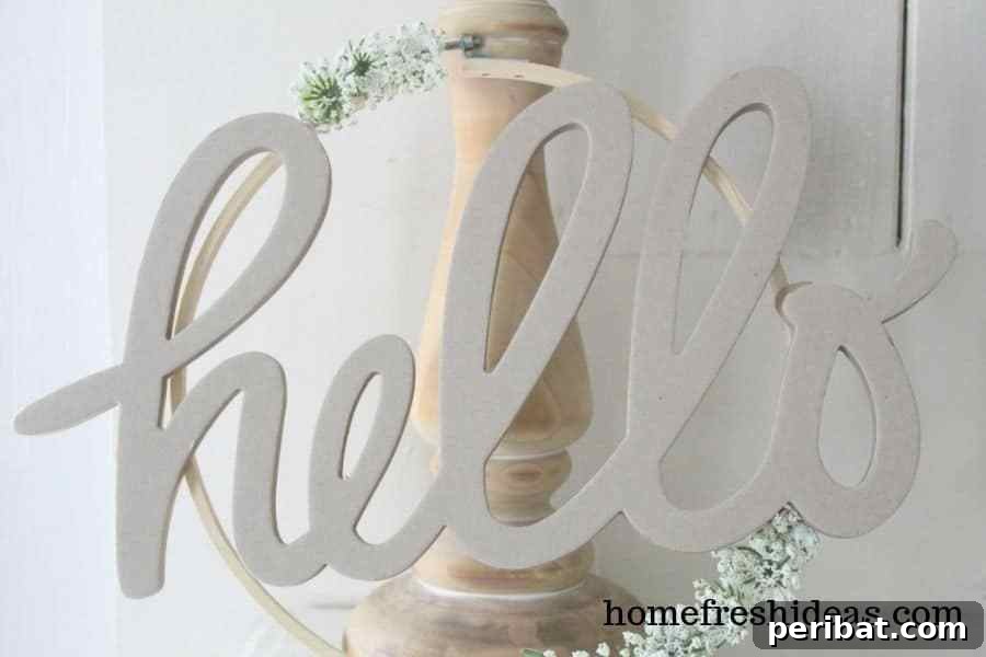 Rustic Farmhouse Wreaths for Year-Round Beauty 10 Charming farmhouse wreath with a 'Hello' sign and rustic elements