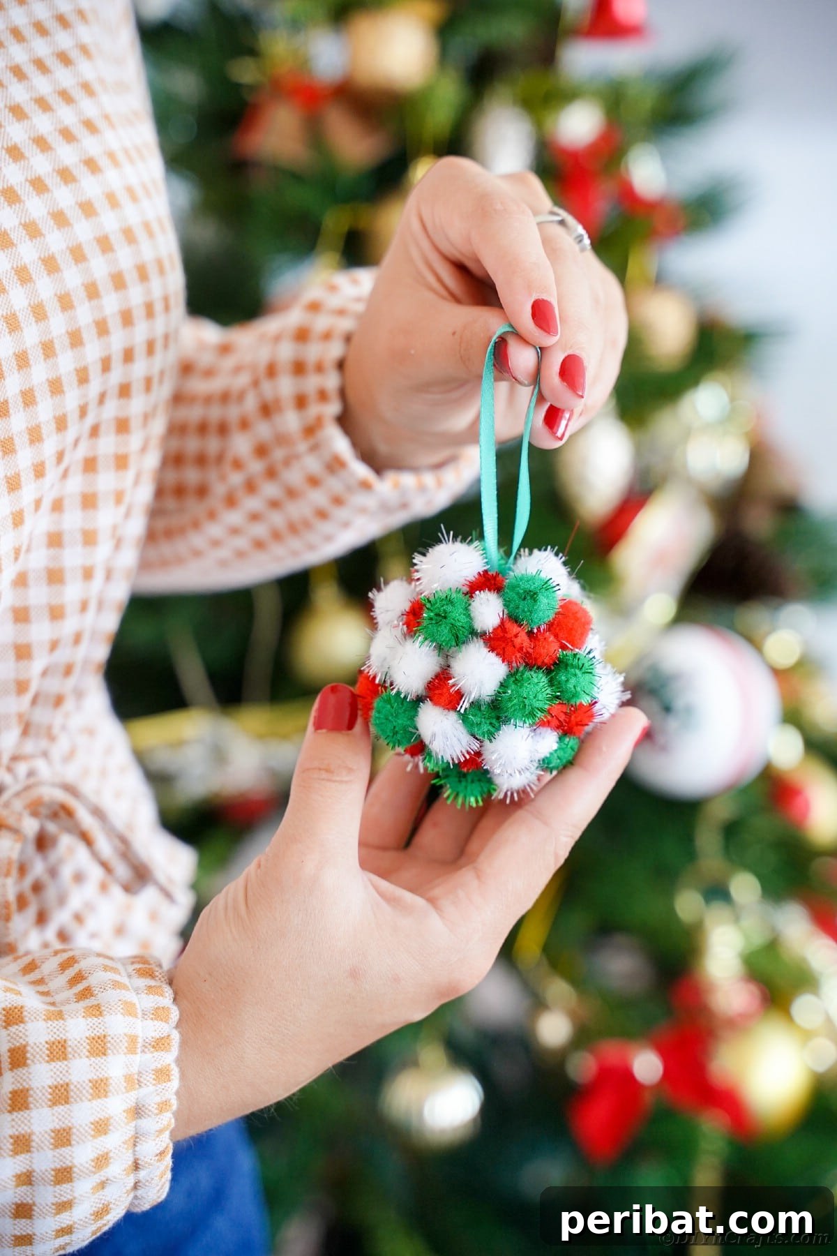 Craft Your Own Fluffy Pom Pom Christmas Ornaments 13 Woman holding ornament