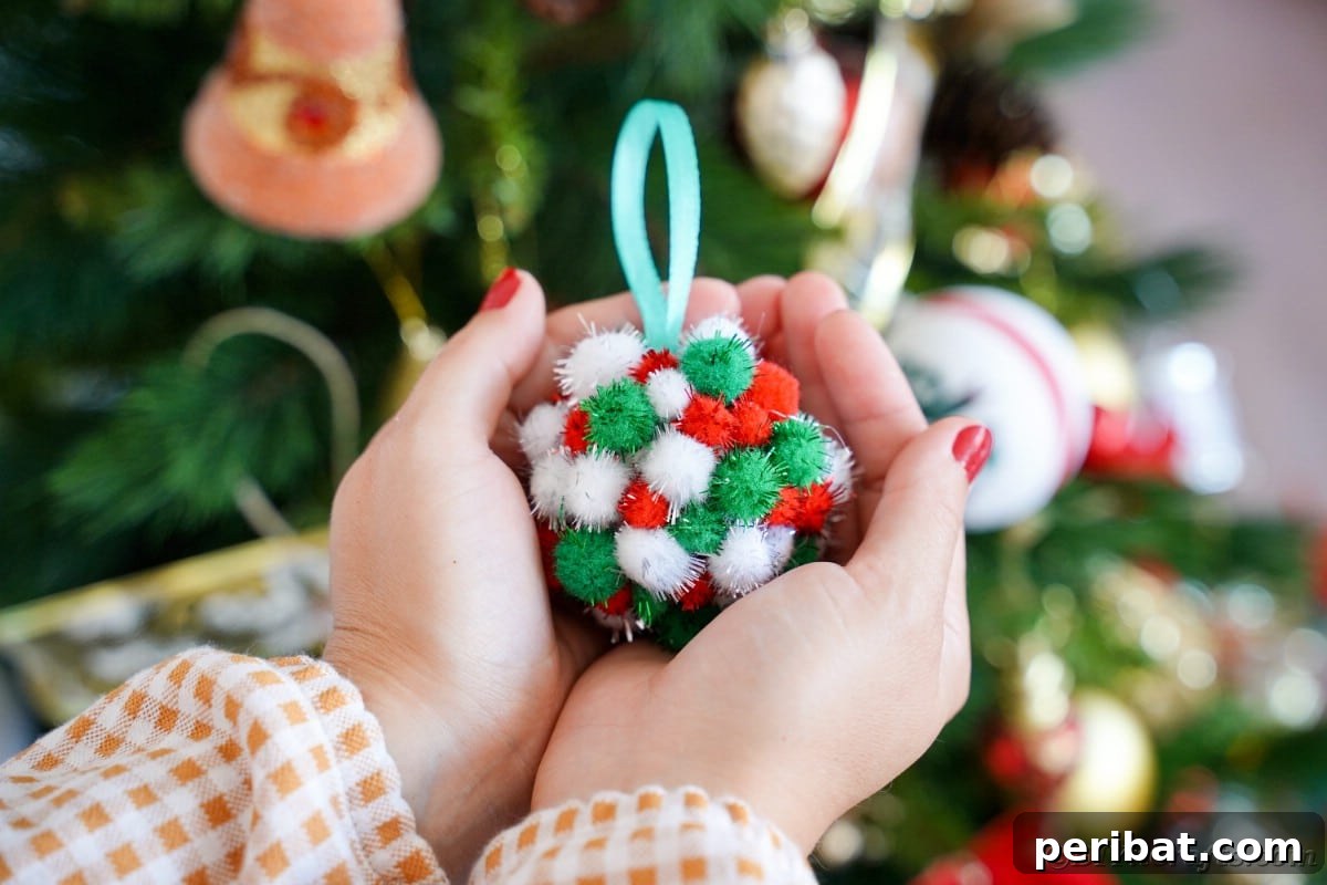 Craft Your Own Fluffy Pom Pom Christmas Ornaments 4 Woman holding ornament