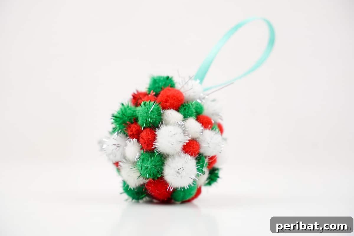 Craft Your Own Fluffy Pom Pom Christmas Ornaments 6 Pom Pom ornament on white surface