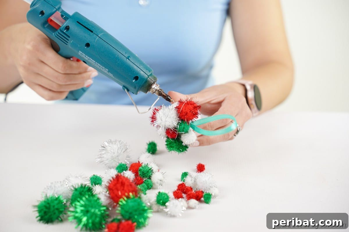 Craft Your Own Fluffy Pom Pom Christmas Ornaments 10 Gluing pom poms onto ball
