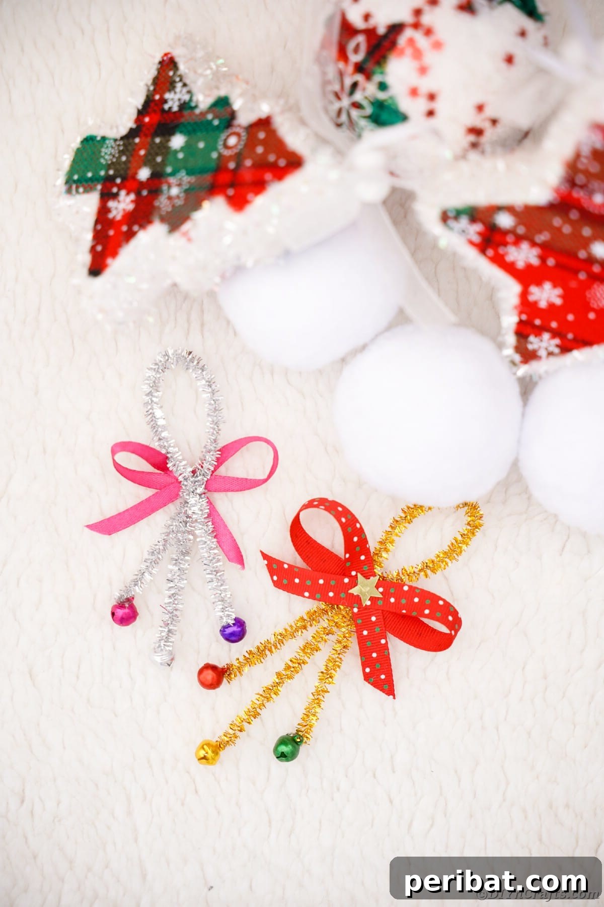 Whimsical Pipe Cleaner Jingle Bell Ornaments for Kids 15 A finished pipe cleaner jingle bell ornament featuring red pipe cleaners and a red bow, on a white table