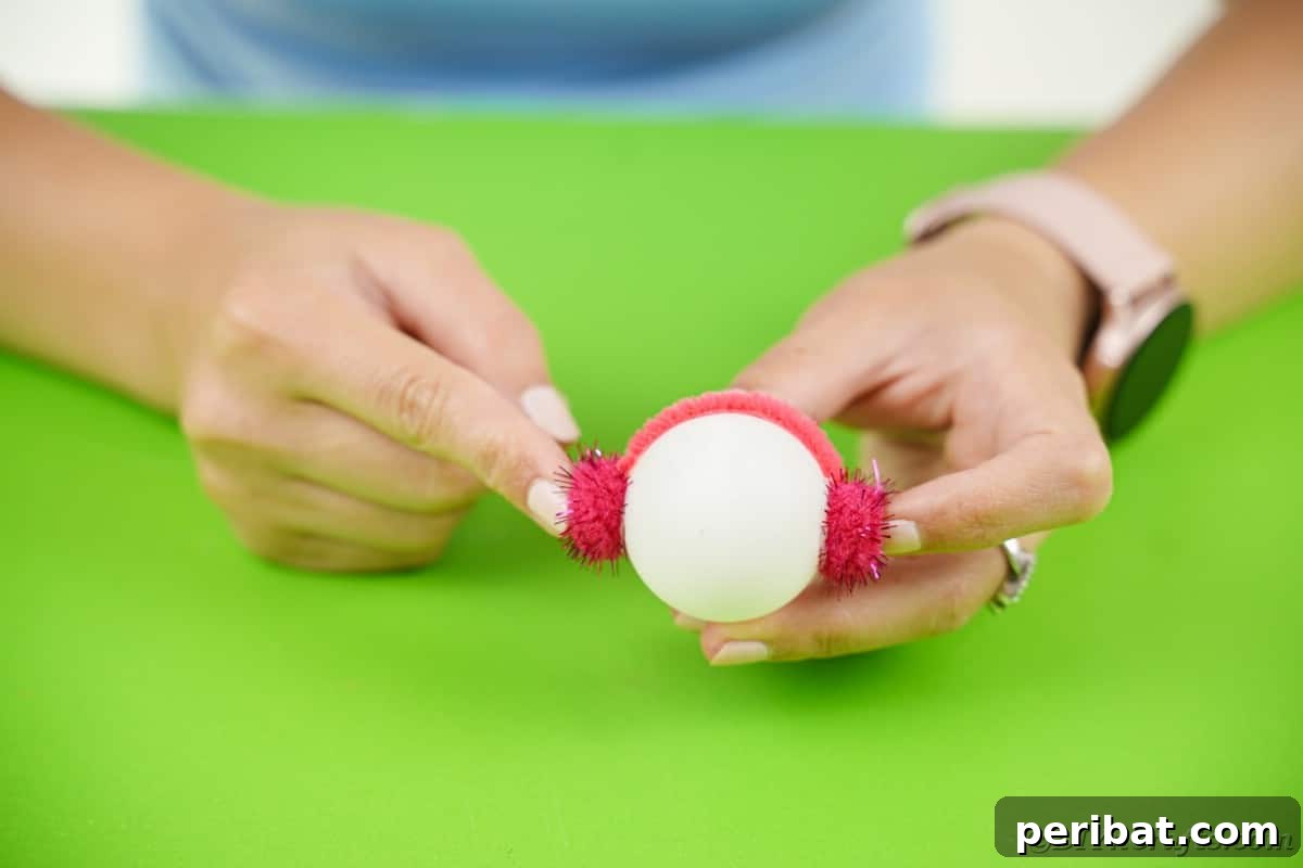 Handcrafted Ping Pong Snowman Holiday Ornaments 12 Adding pipe cleaner earmuff to ping pong ball