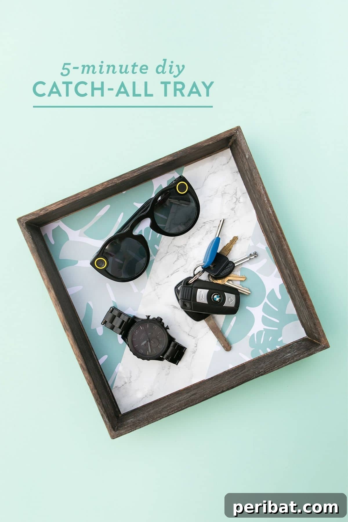 A sleek square wooden catch-all tray with sunglasses inside, ideal for organizing small items.
