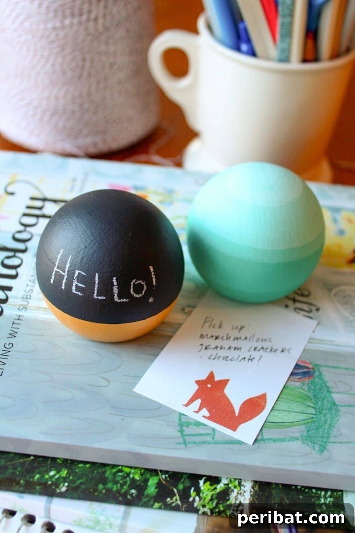 A collection of round paperweights crafted from upcycled door knobs, in varying shades of blue.