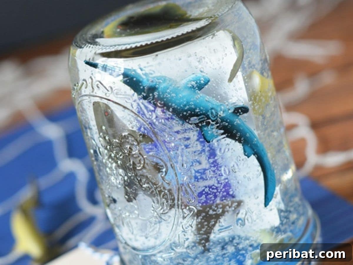 A creative Father's Day gift featuring a gift card nestled in a jar with candy and decorative elements.