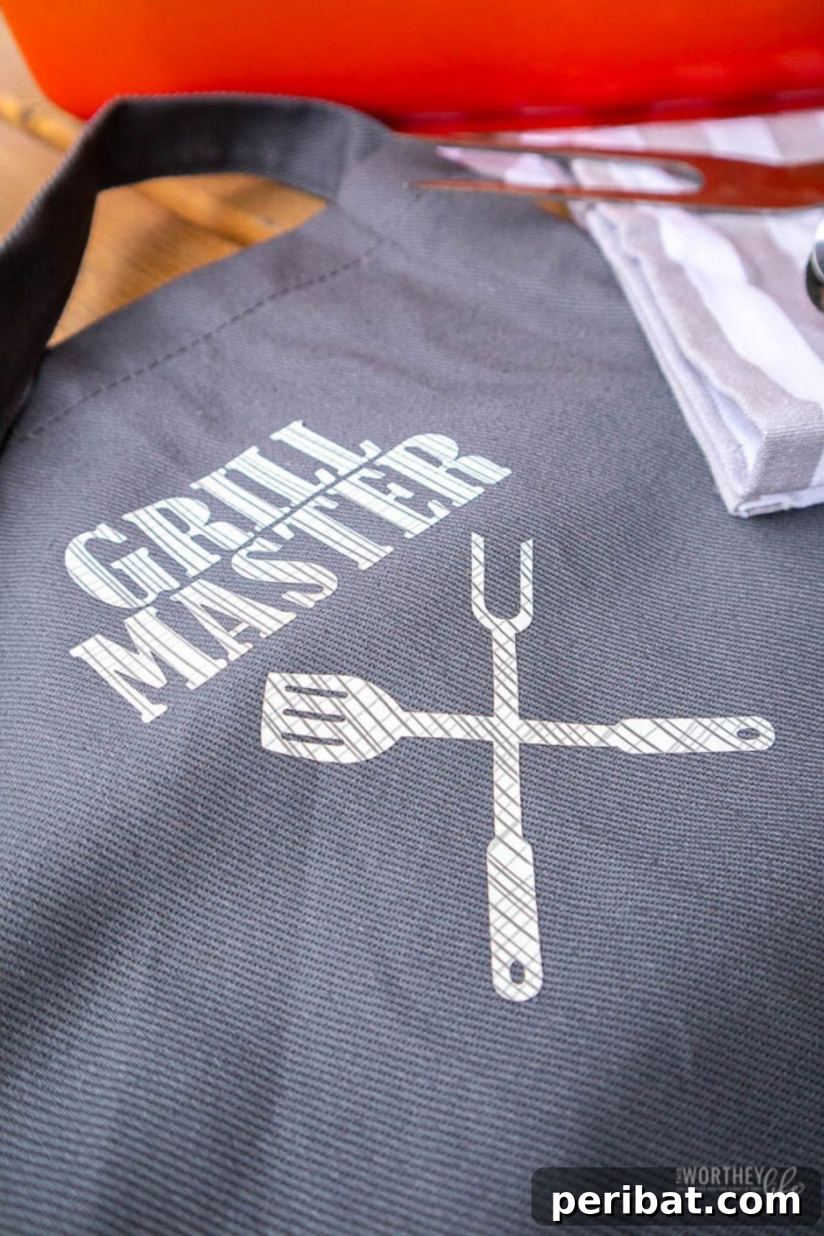 A fun DIY apron emblazoned with 'Grill Master,' perfect for a man who loves to barbecue.