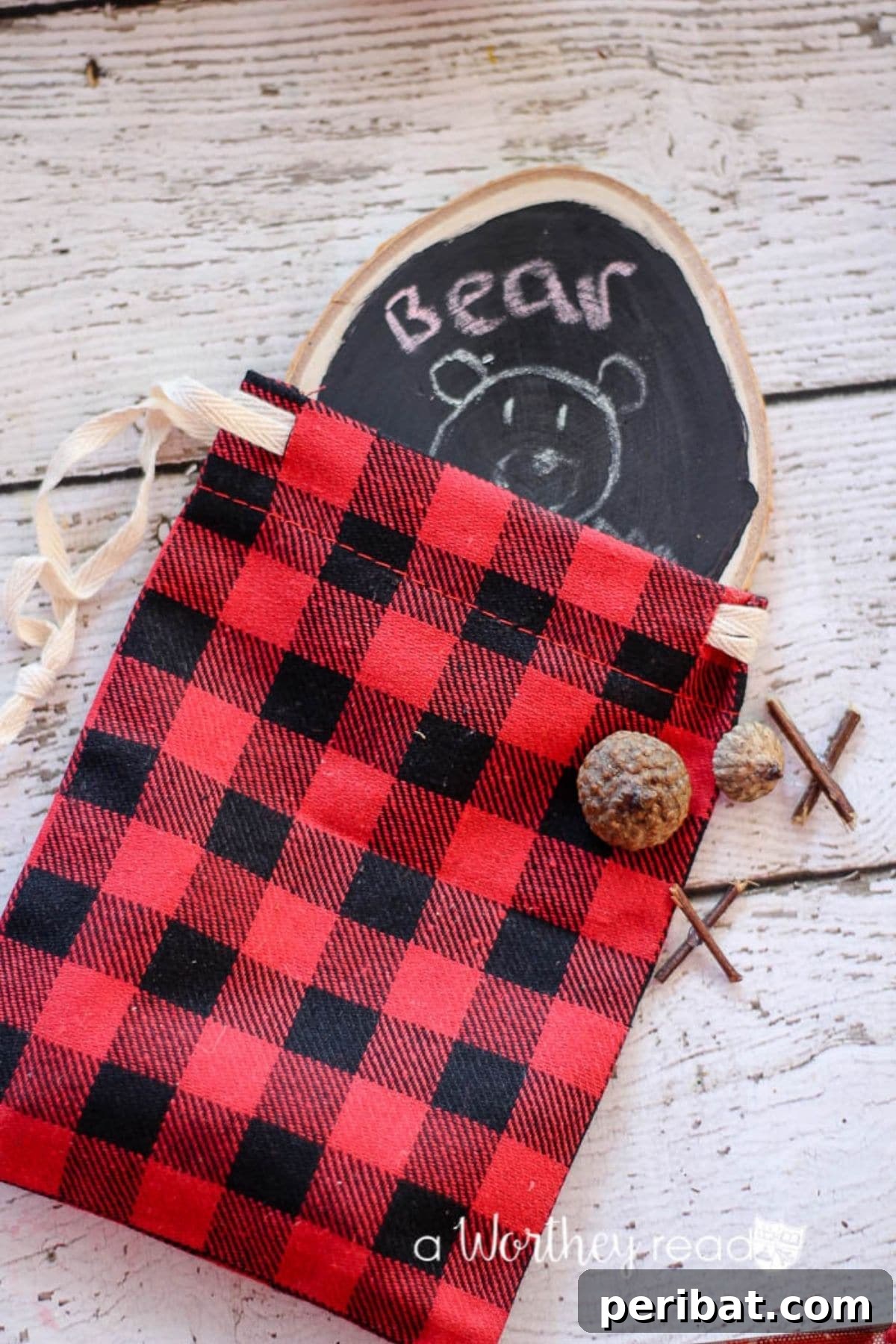 A rustic buffalo plaid pouch containing small game pieces, a charming and portable gift idea.