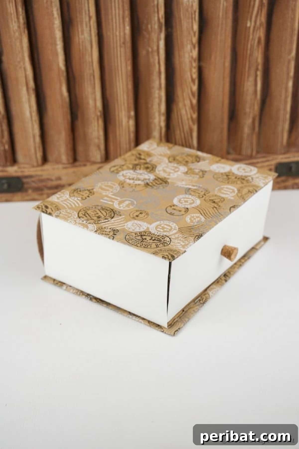 An elegantly decorated upcycled cardboard box storage drawer, a clever DIY solution for children to store their keepsakes, small toys, or craft supplies.