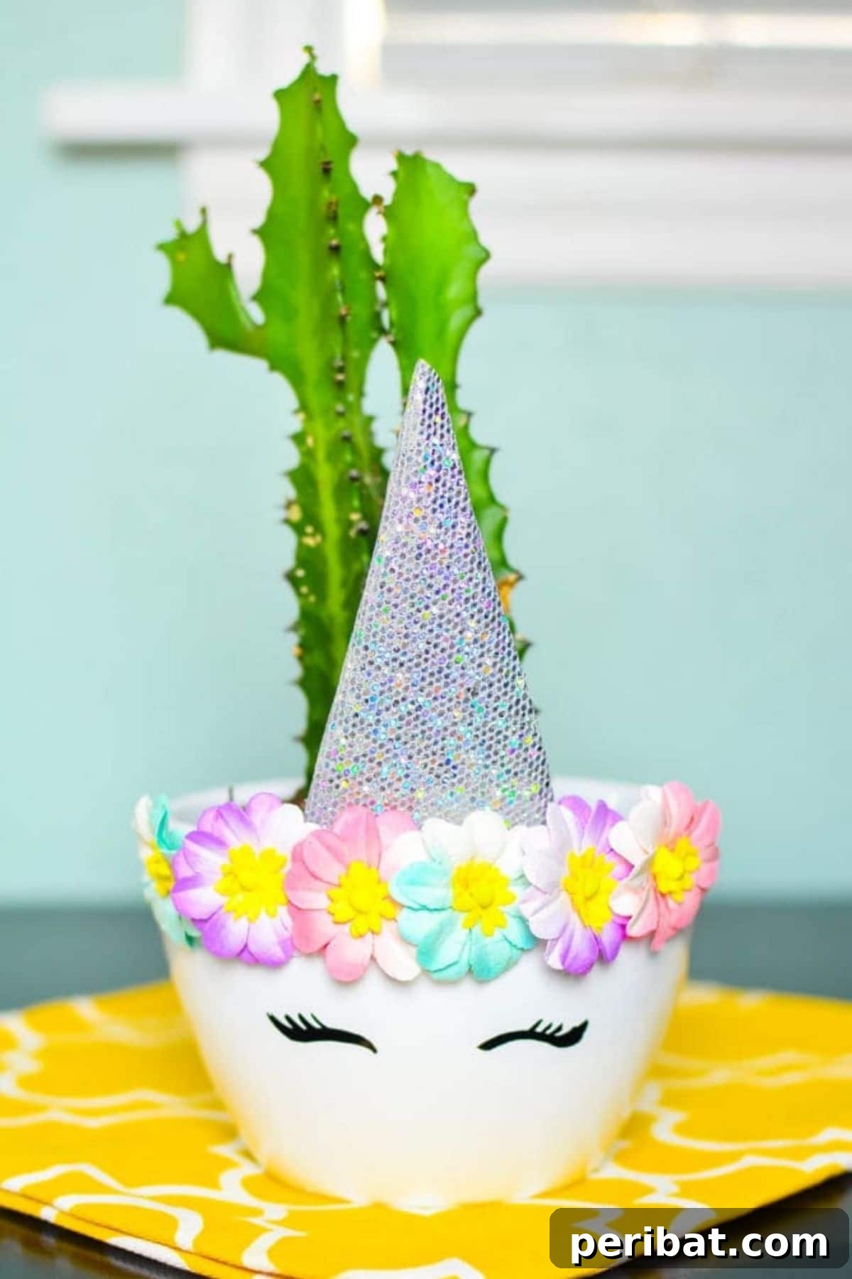 A magical DIY unicorn planter, featuring a whimsical design with a golden horn and floral embellishments, perfect for adding a touch of fantasy to a child's room with a succulent.