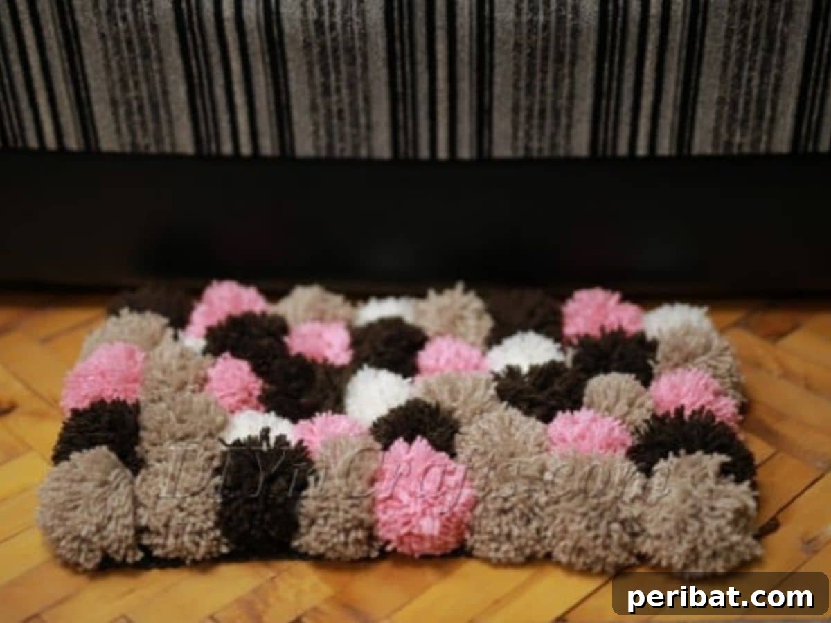 A cozy and colorful homemade pom pom rug, showcasing a soft and inviting texture, perfect as a decorative and comfortable addition to a child's room.