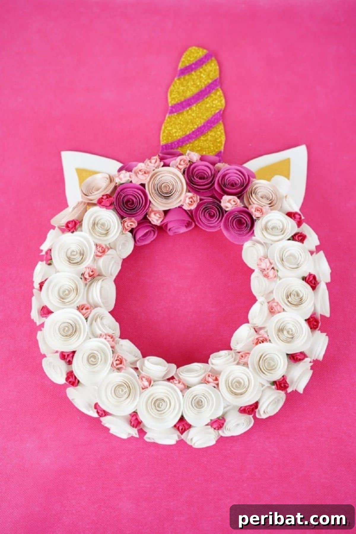 A stunning rolled paper unicorn wreath, featuring intricate paper flowers and a golden horn, a perfect magical DIY decor piece for a child's unicorn-themed bedroom.