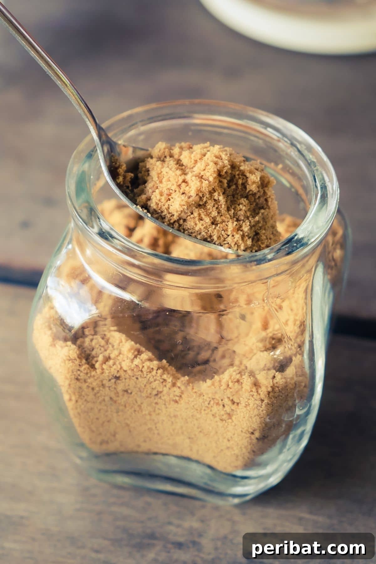 Jar of brown sugar with an orange peel inside