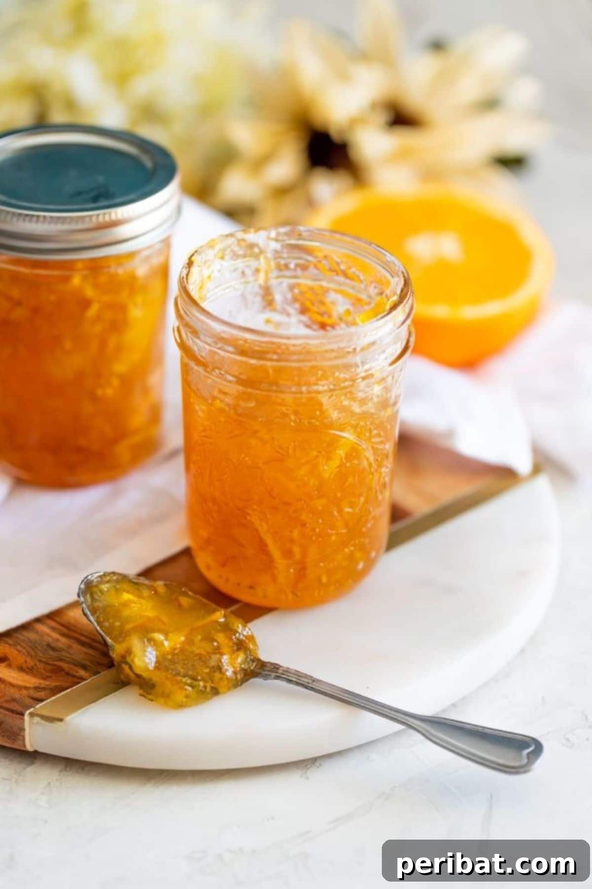 Jar of homemade orange marmalade on a rustic surface