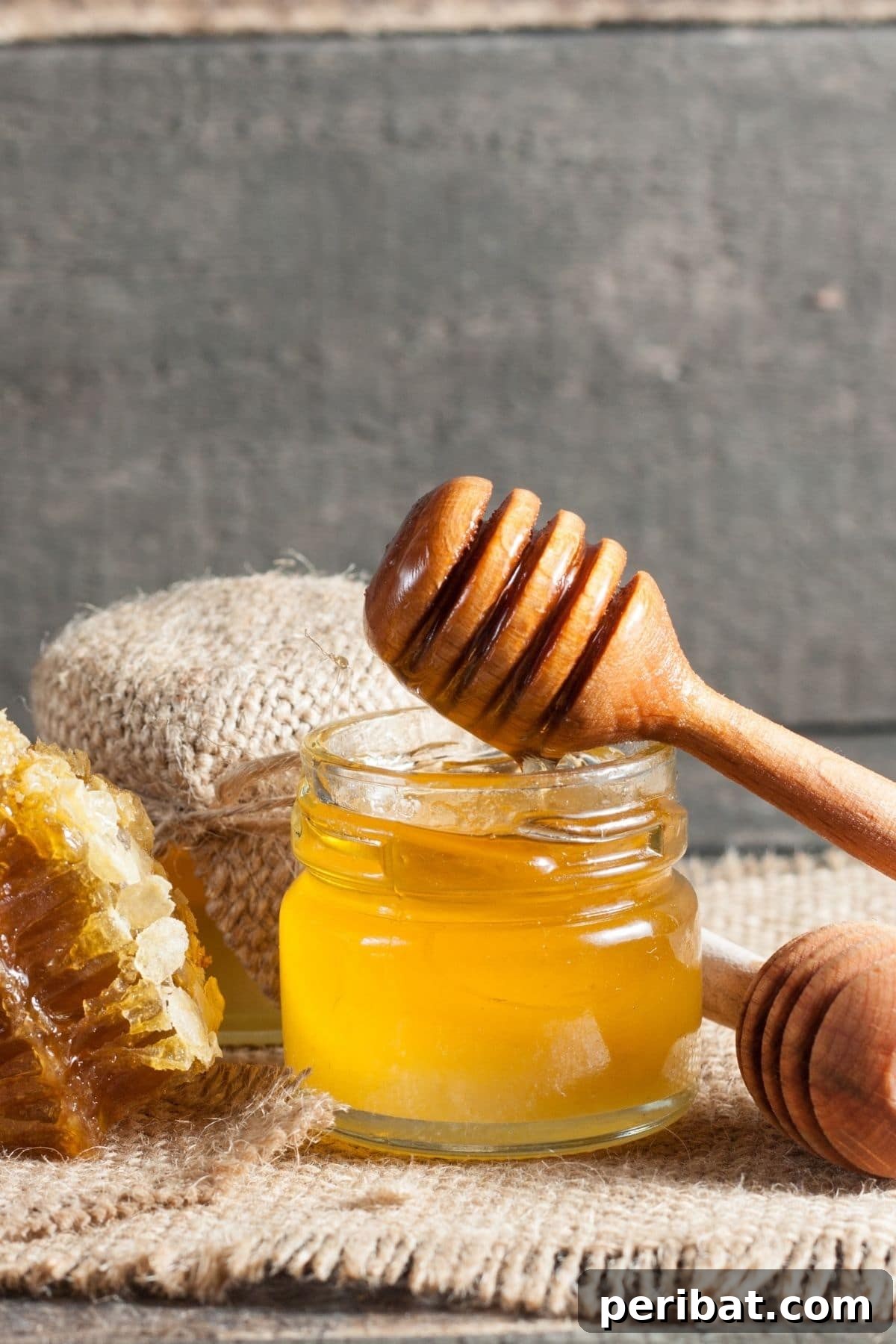 Jar of raw honey infused with orange peels
