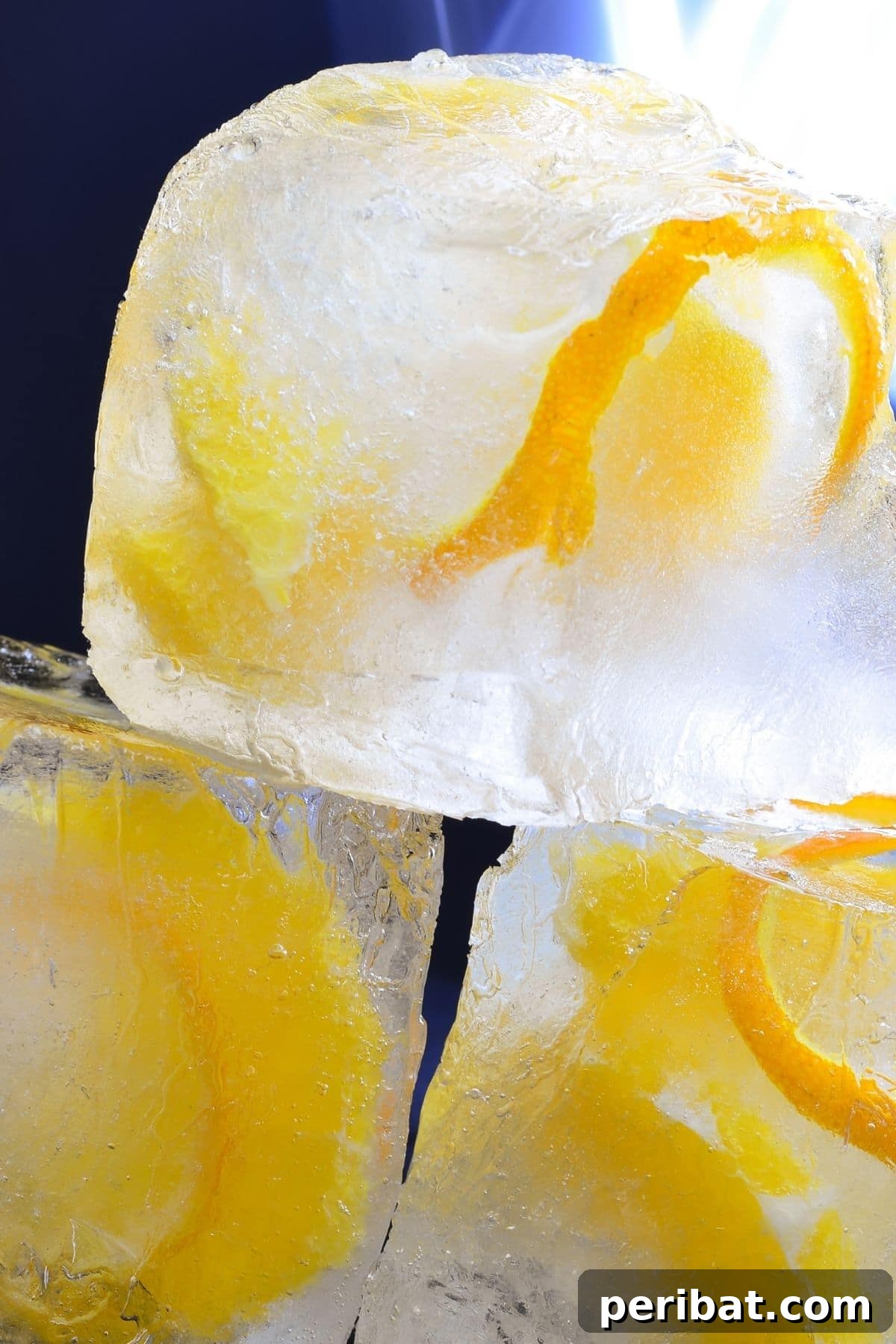 Ice cube tray with orange peel pieces in water