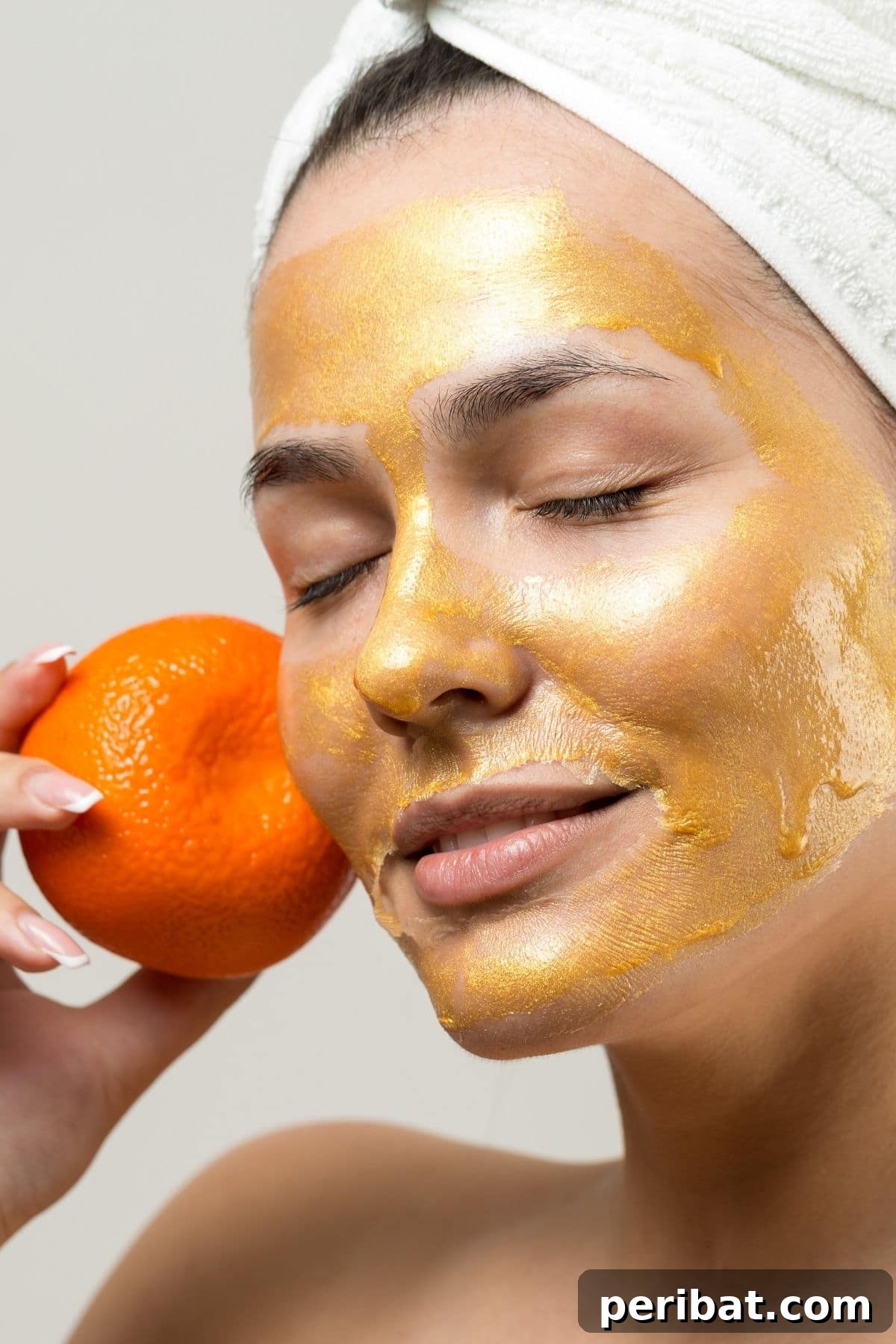 Woman applying an orange face mask