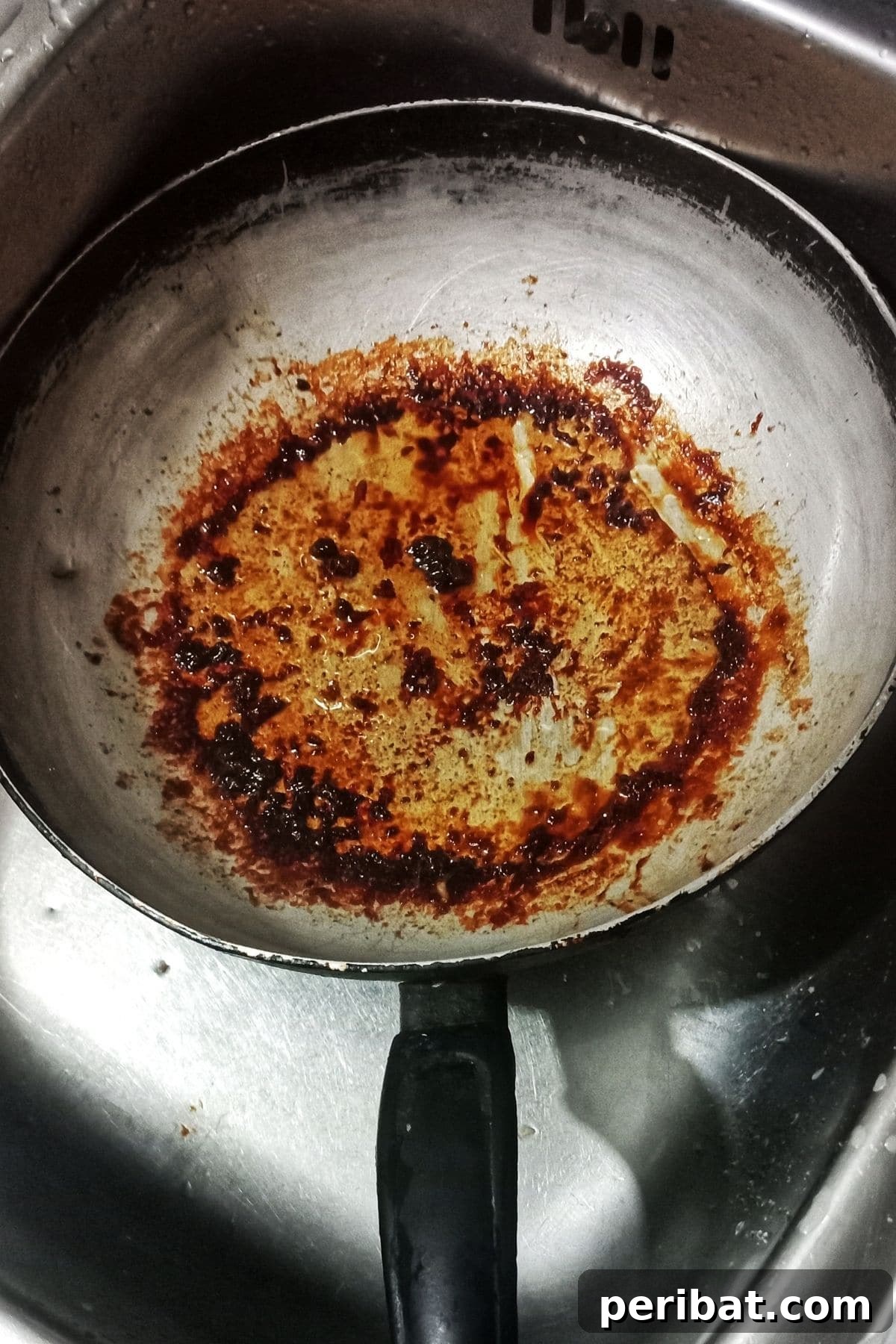 Dirty, scorched pan in a sink